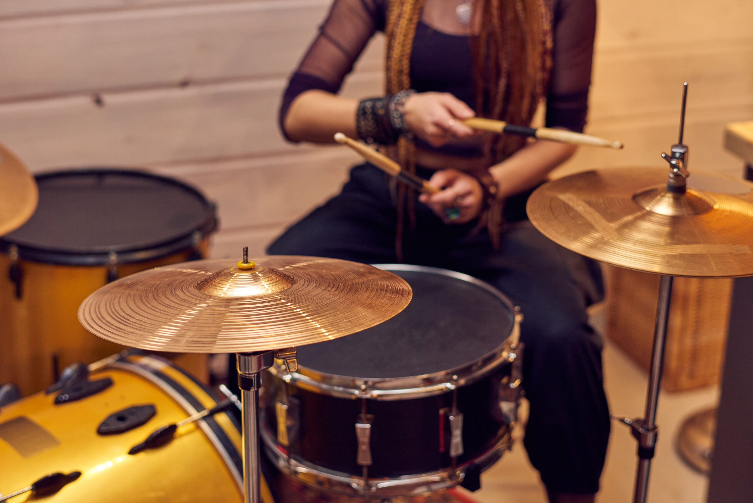 girl plays drum set